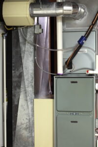 Newly installed residential furnace unit in a utility room, representing a modern heater replacement.