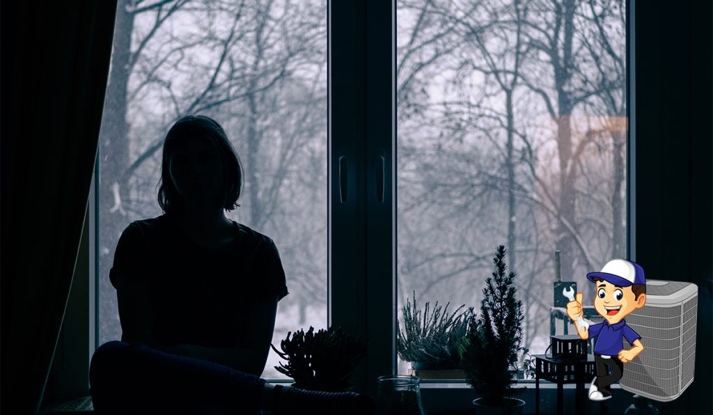 Rear View Of Silhouette Woman Sitting By A Winter Window