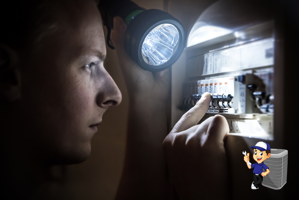 A man with a flashlight in the dark checking his breaker box.